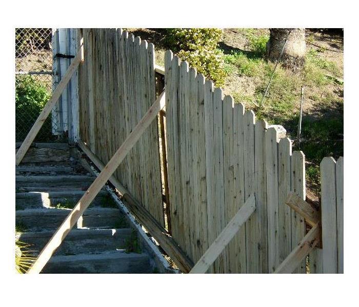 Storm knocks down fence.