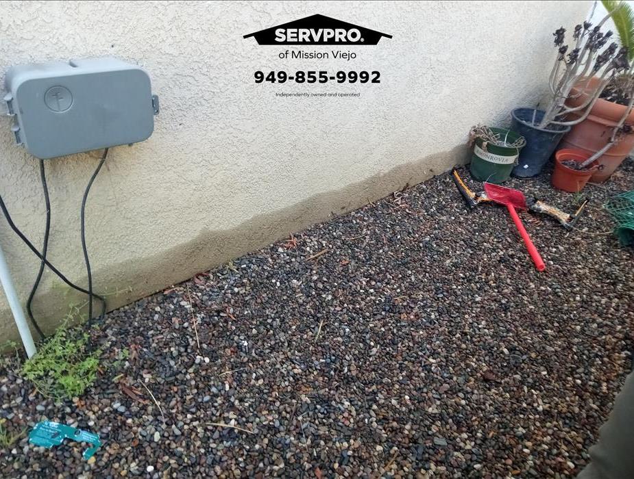 Water intrusion from outdoor sprinkler system.